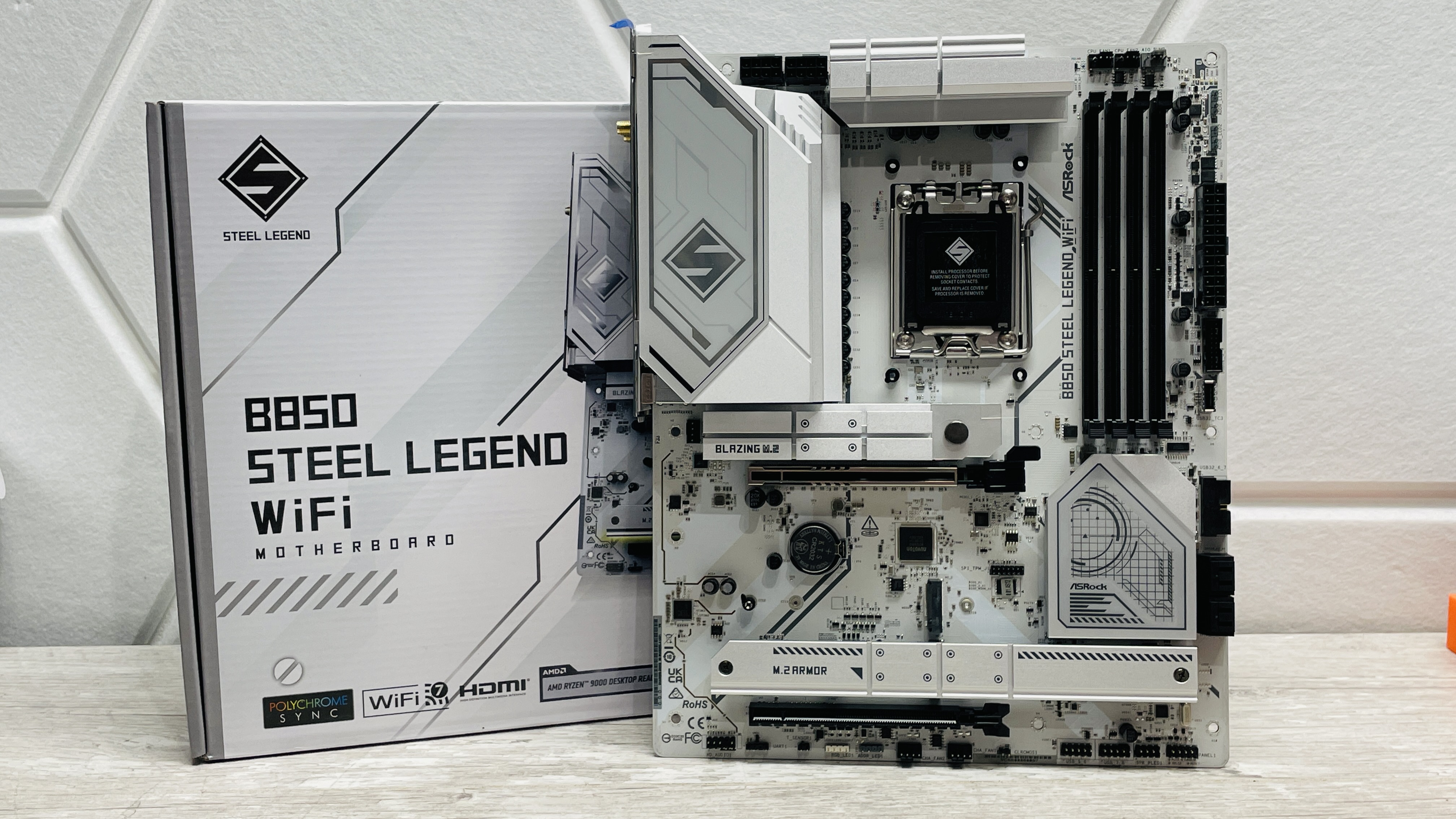 ASRock B850 Steel Legend Wi-Fi motherboard on a desk.